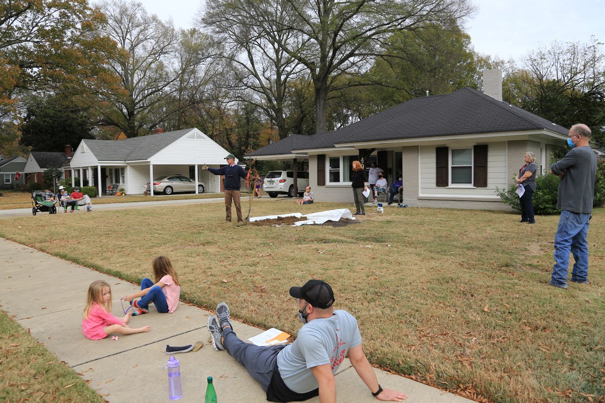 Neighbors gathered at social distances in the front lawn of Tim and Dawn Edwards' home